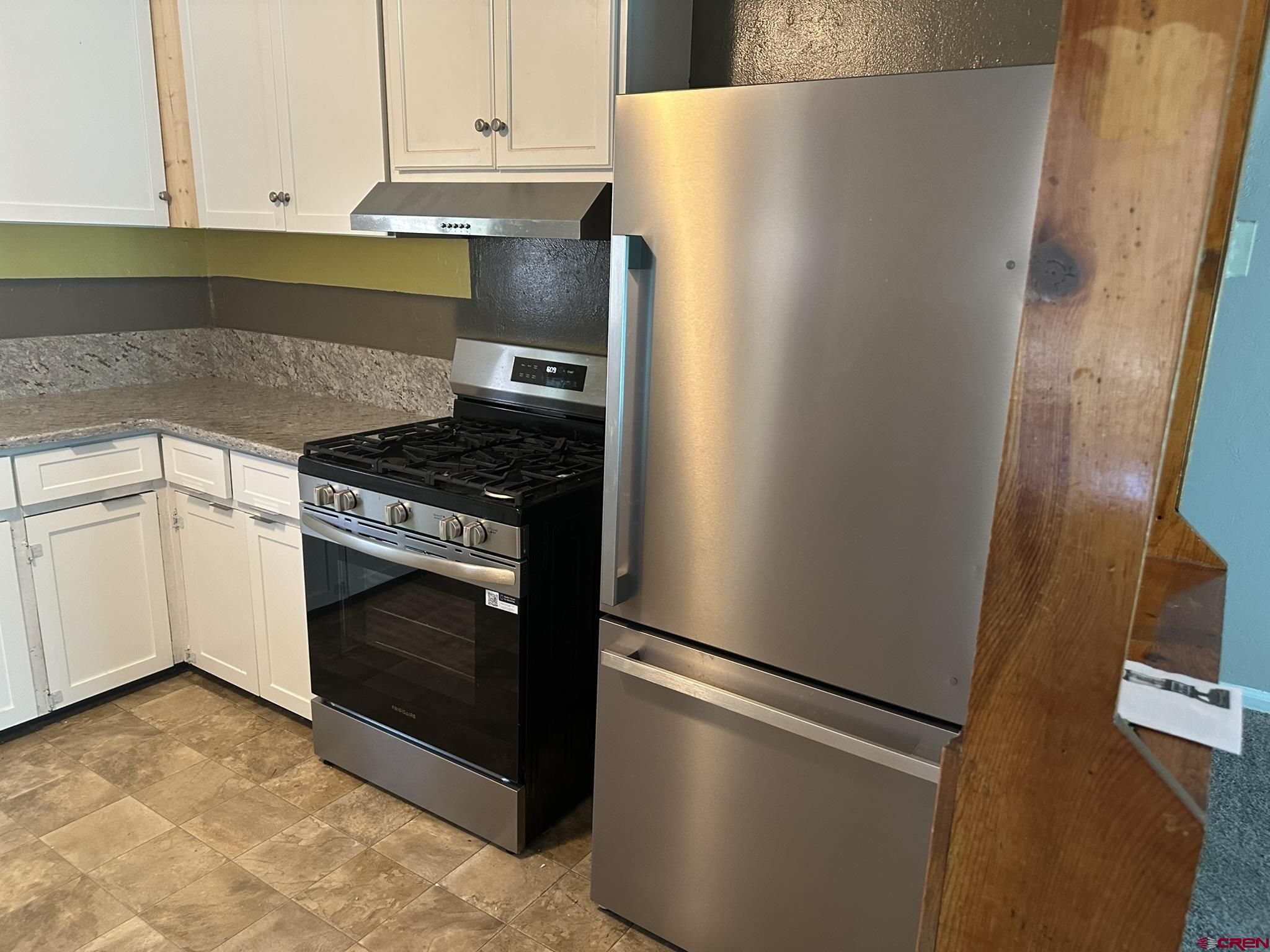 435 South Elm Street Cortez, CO 81321 - Photo 6 of 17 a white refrigerator freezer and a stove sitting inside of a kitchen