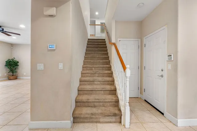 a view of a livingroom with a ceiling fan & window
