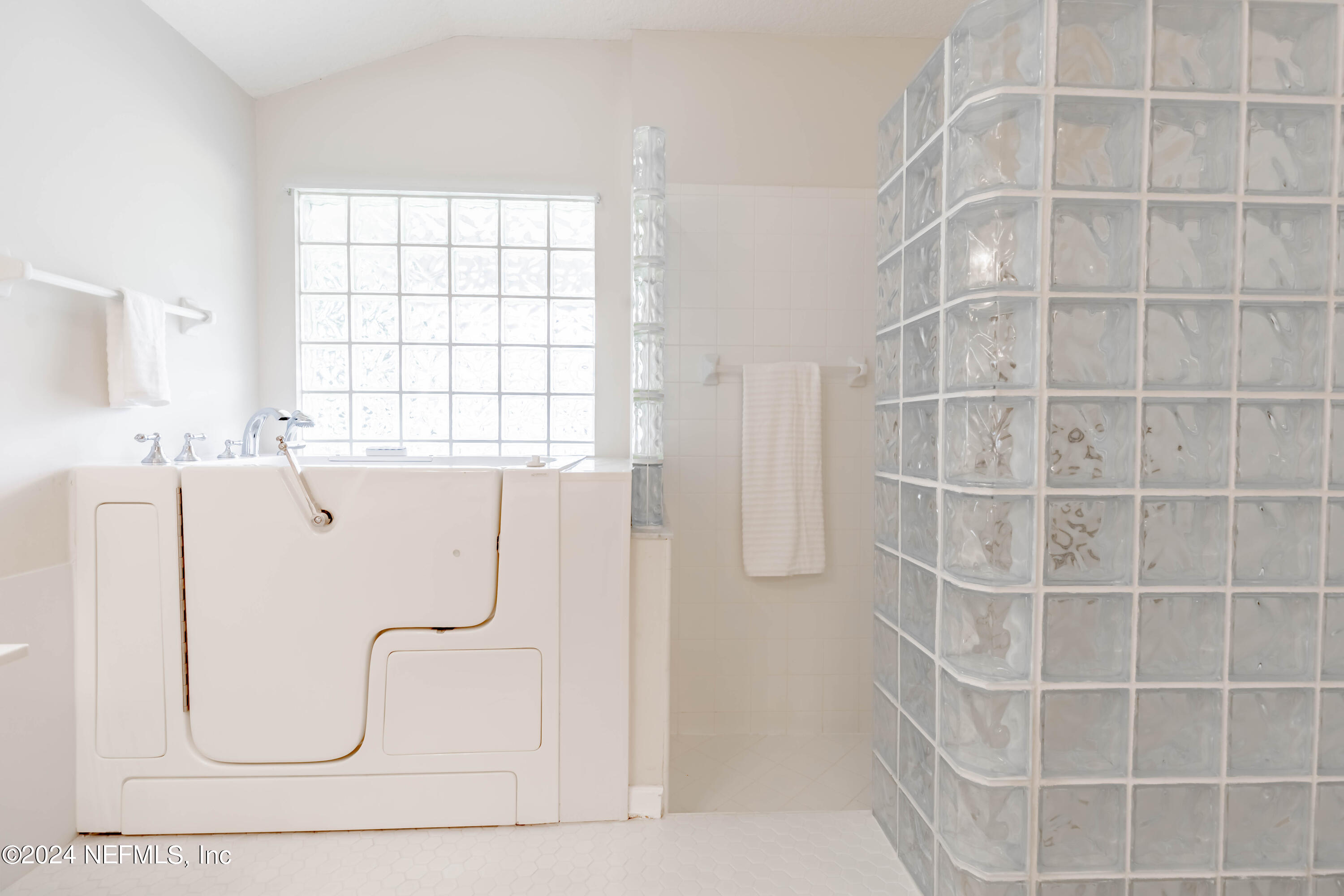 2285 Eagle Harbor Parkway Fleming Island, FL 32003 - Photo 11 of 59 a bathroom with a bathtub and a shower
