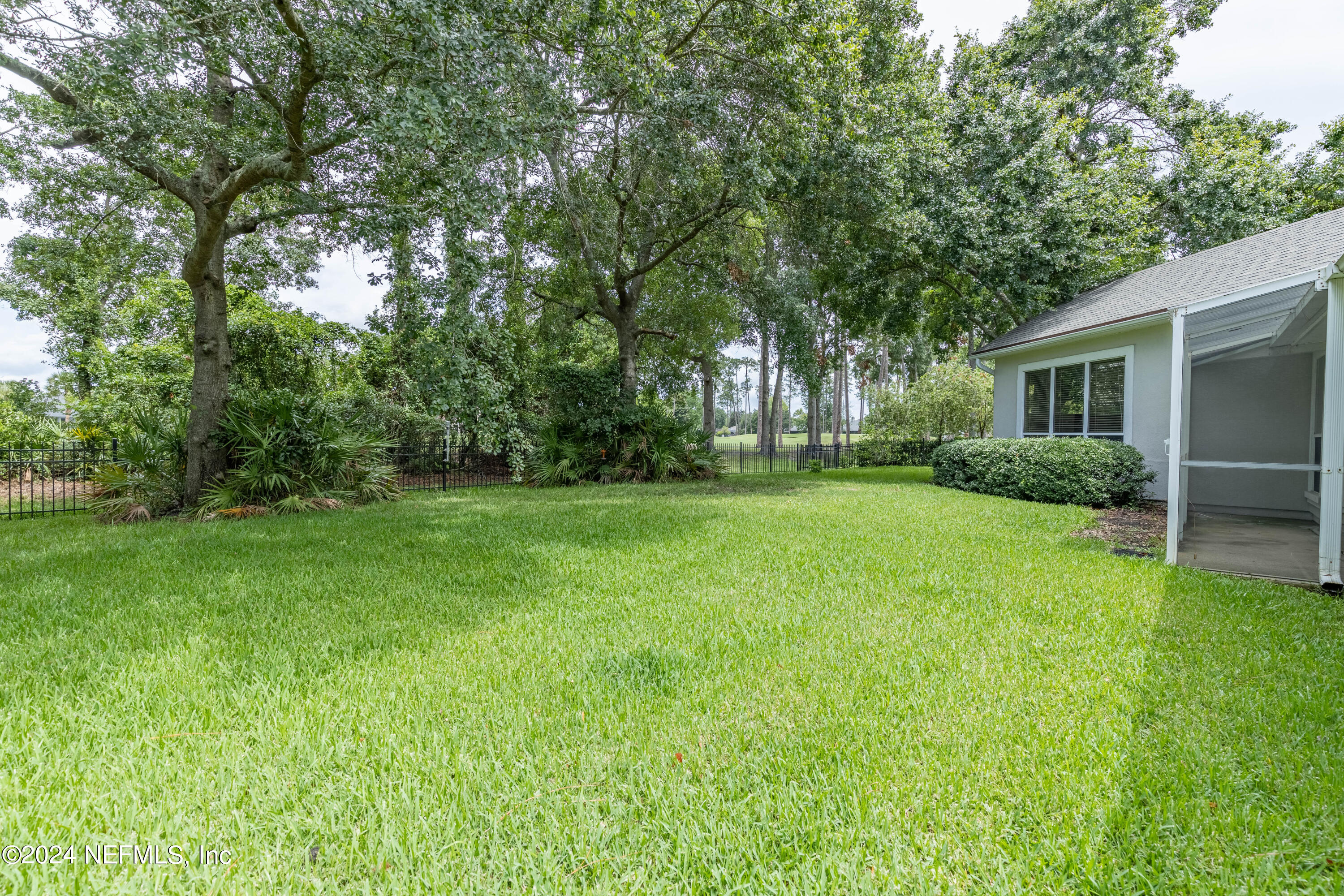 2285 Eagle Harbor Parkway Fleming Island, FL 32003 - Photo 21 of 59 a backyard of a house with large trees and plants