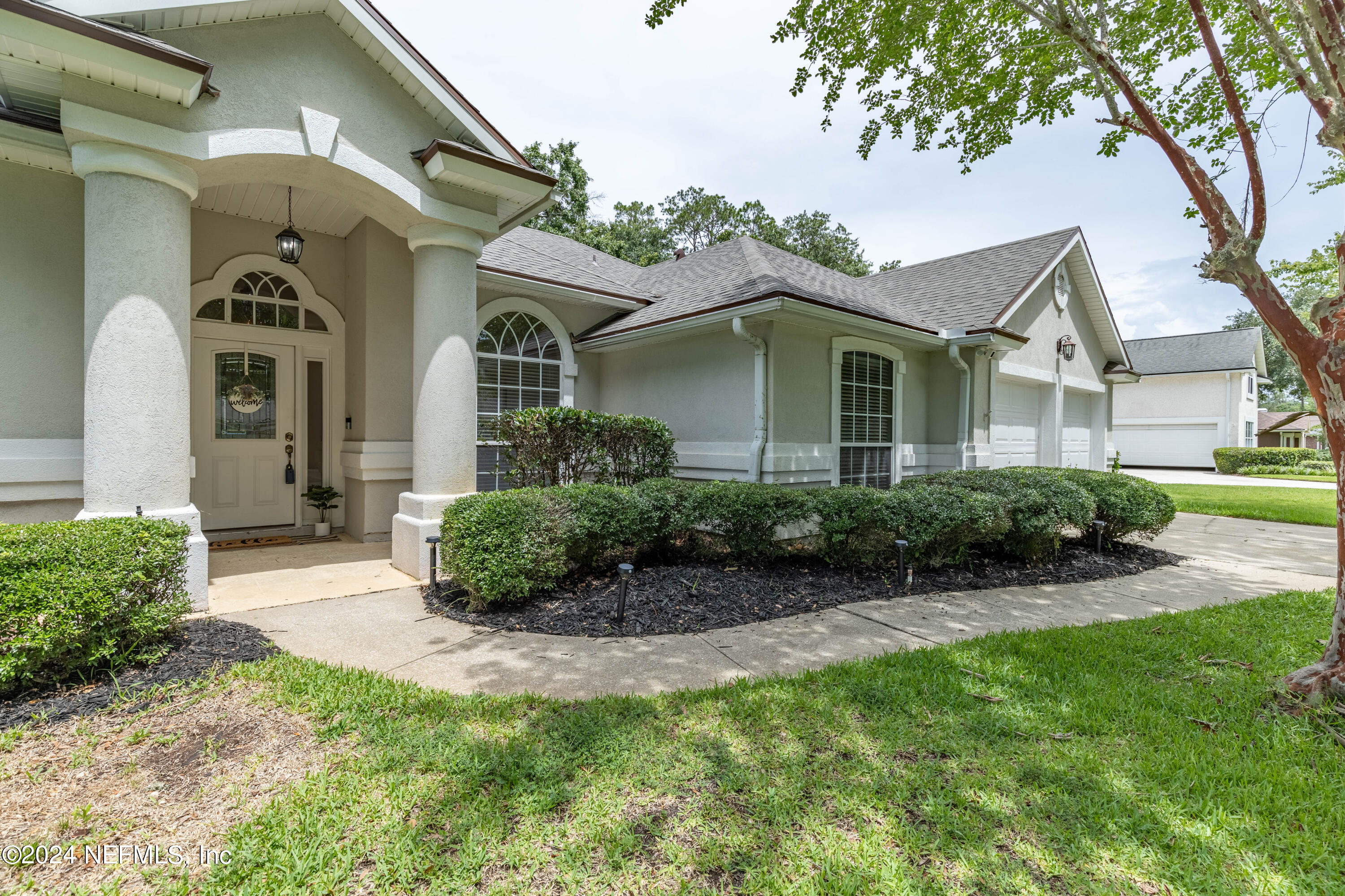 2285 Eagle Harbor Parkway Fleming Island, FL 32003 - Photo 27 of 59 a front view of a house with garden