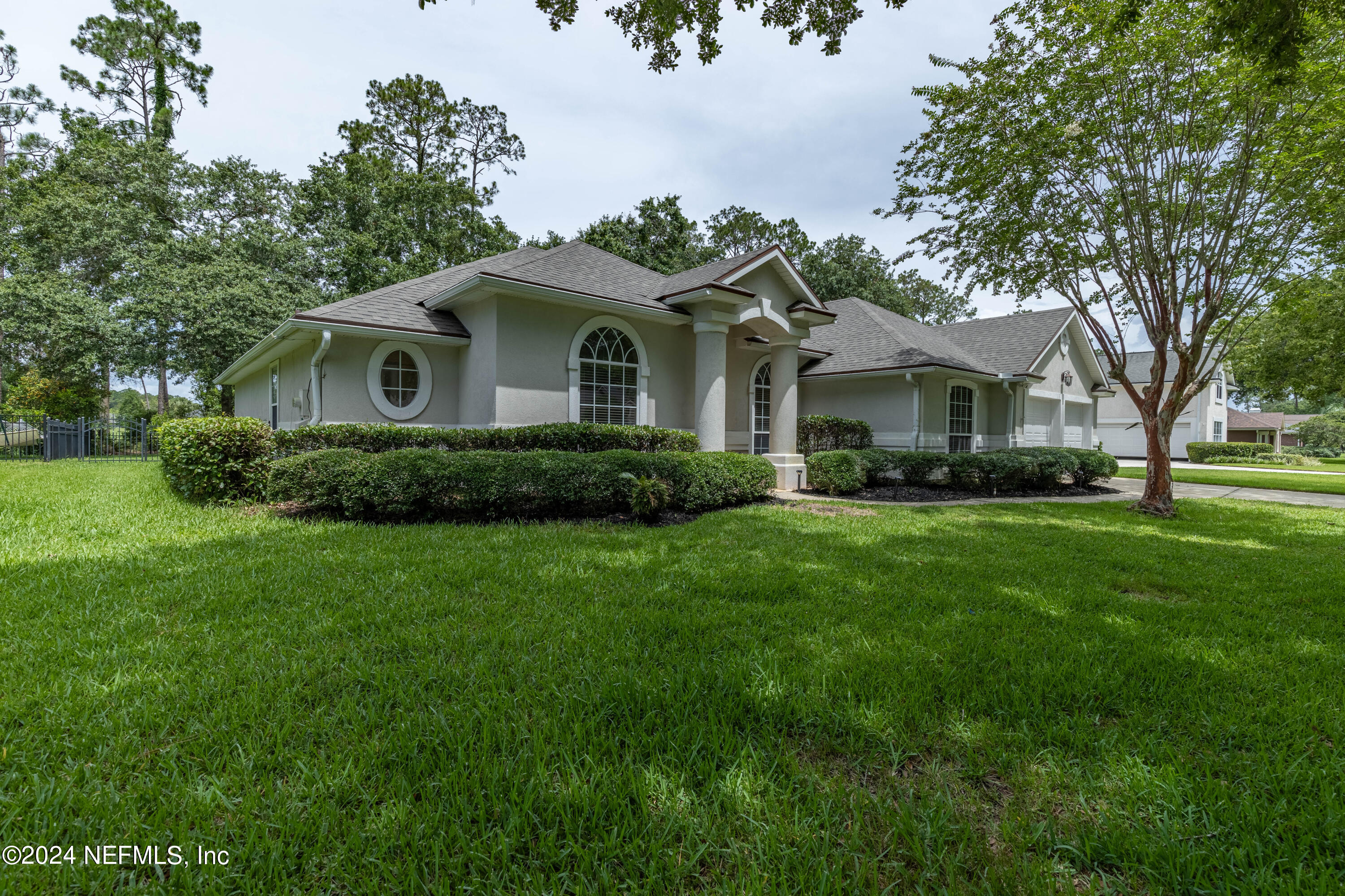 2285 Eagle Harbor Parkway Fleming Island, FL 32003 - Photo 28 of 59 a front view of a house with a garden and trees