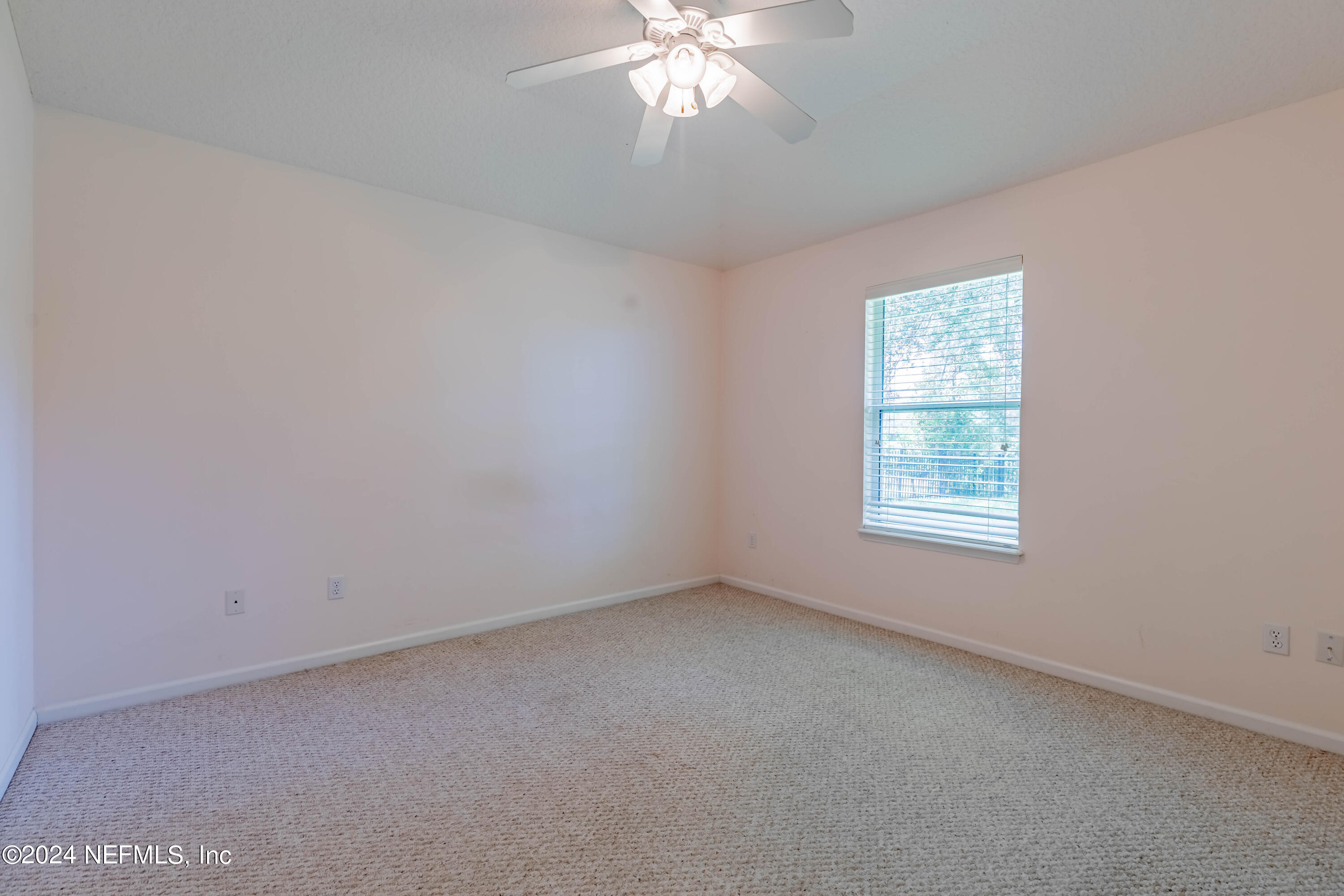 2285 Eagle Harbor Parkway Fleming Island, FL 32003 - Photo 44 of 59 an empty room with a chandelier fan and windows