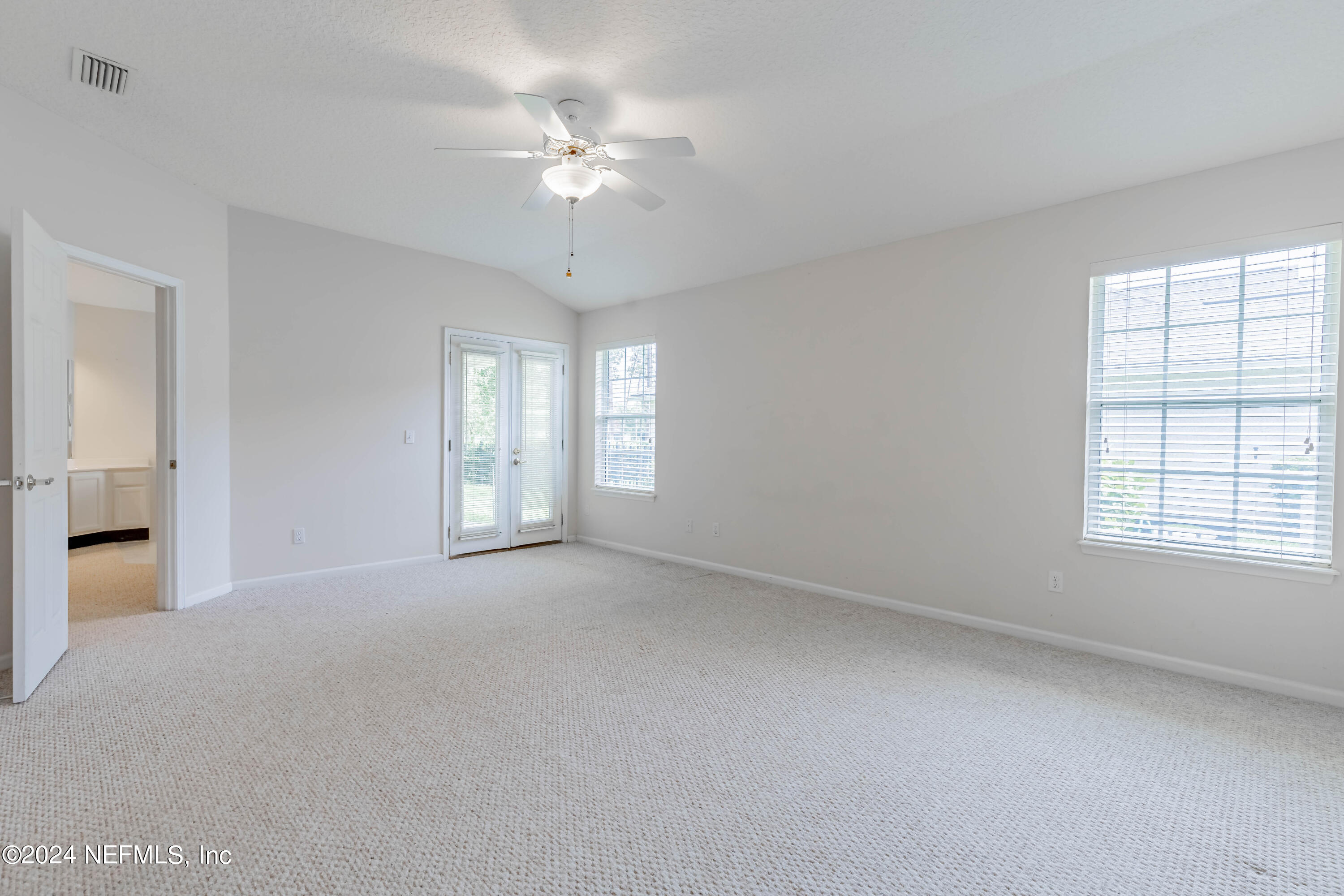 2285 Eagle Harbor Parkway Fleming Island, FL 32003 - Photo 46 of 59 an empty room with chandelier fan and windows