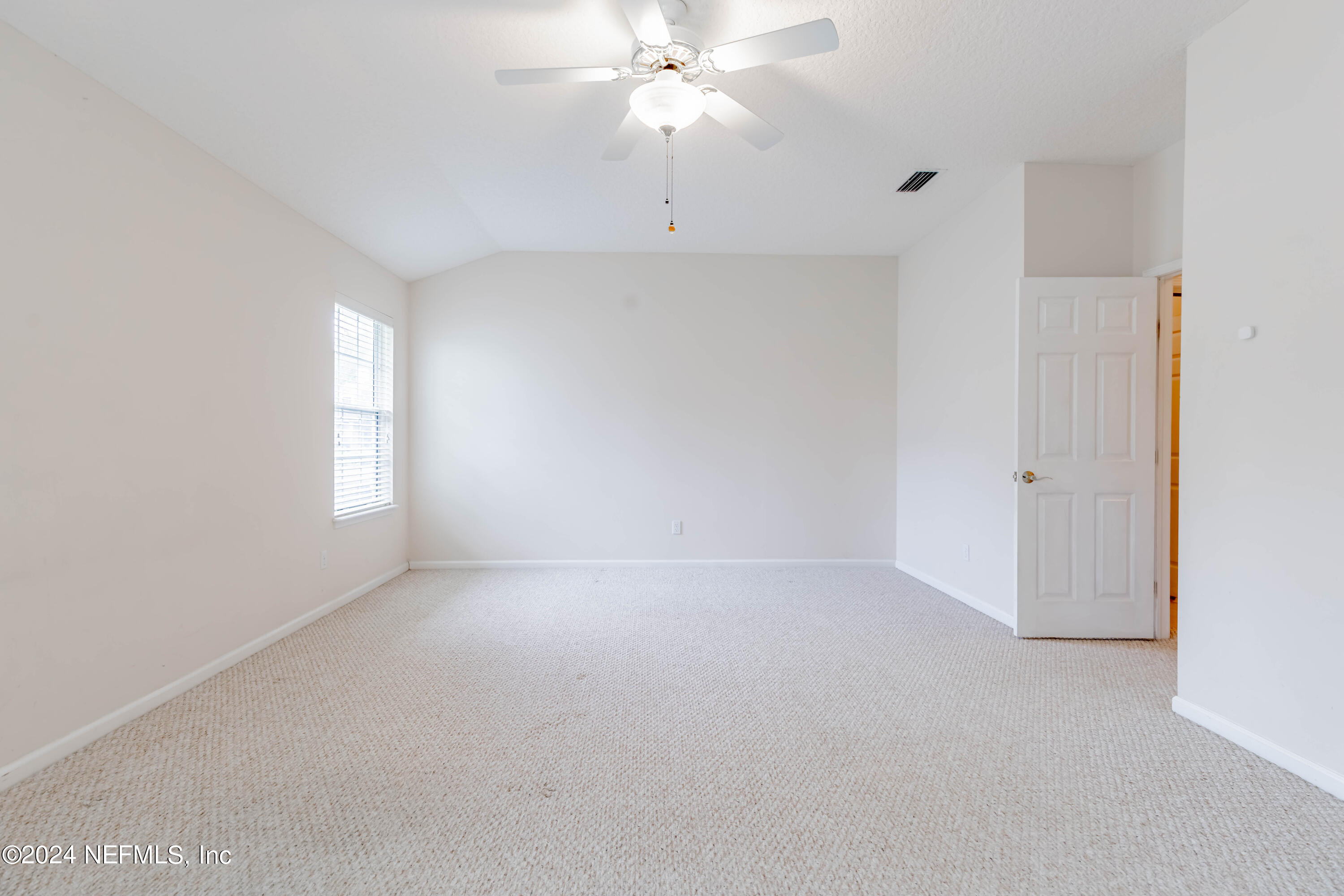 2285 Eagle Harbor Parkway Fleming Island, FL 32003 - Photo 49 of 59 an empty room with chandelier fan and windows