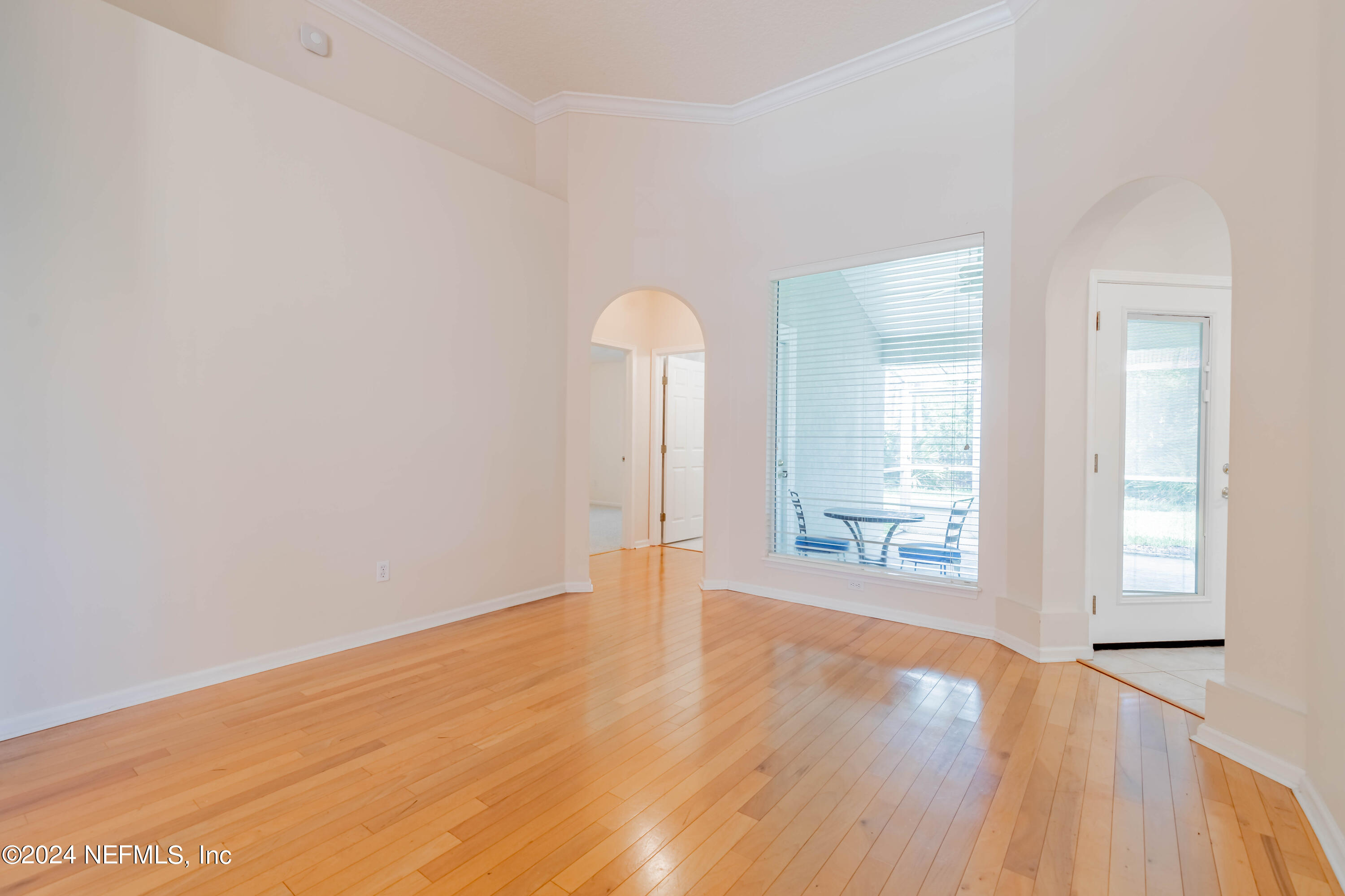 2285 Eagle Harbor Parkway Fleming Island, FL 32003 - Photo 5 of 59 an empty room with wooden floor and windows