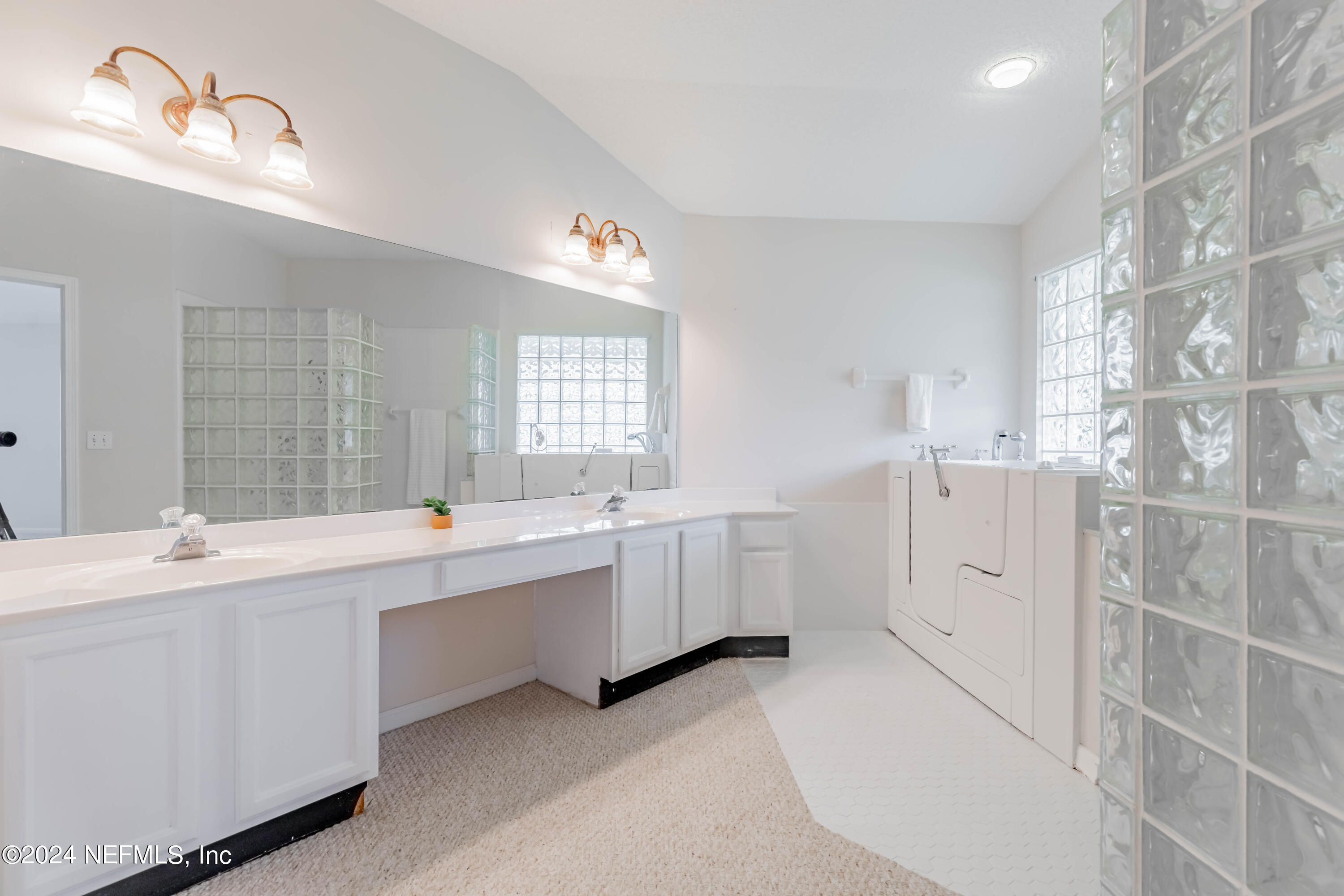 2285 Eagle Harbor Parkway Fleming Island, FL 32003 - Photo 10 of 59 a large white bathroom with double vanity and a large mirror