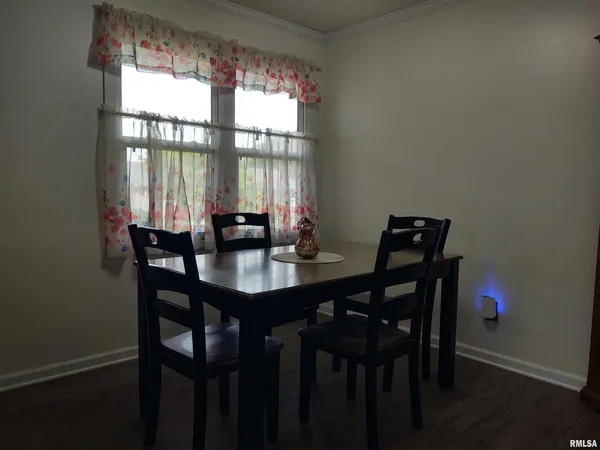 a view of a dining room with a table and chairs