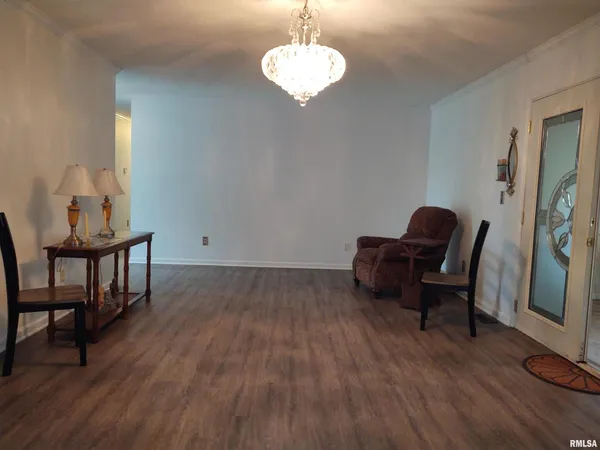 a view of a workspace with furniture and wooden floor