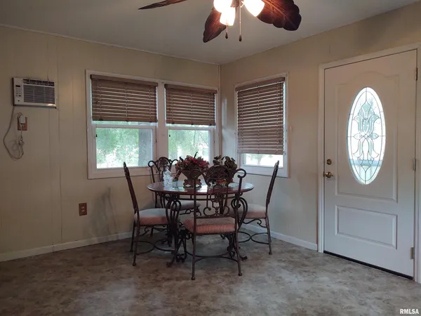 a dining room with furniture and window