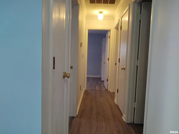 a view of a hallway with wooden floor