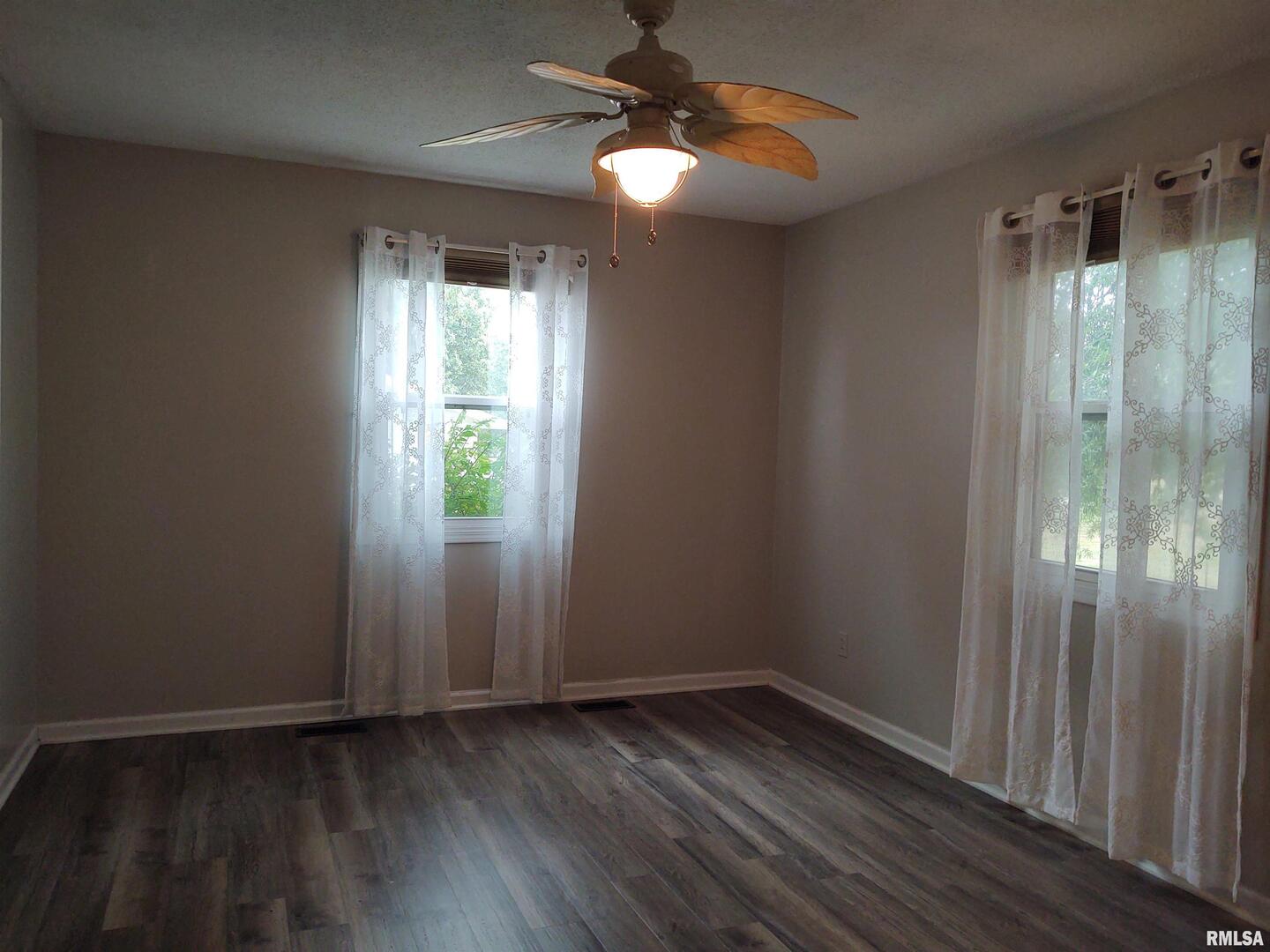 110 Stork Street Anna, IL 62906 - Photo 20 of 27 a view of an empty room with window wooden floor and cabinet