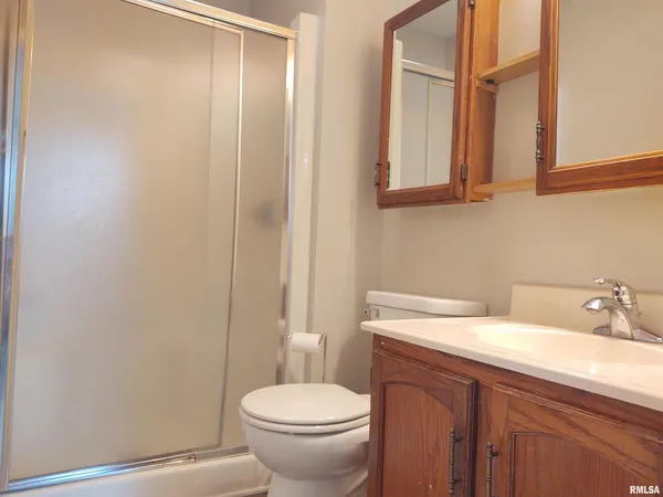 a bathroom with a sink a toilet and mirror