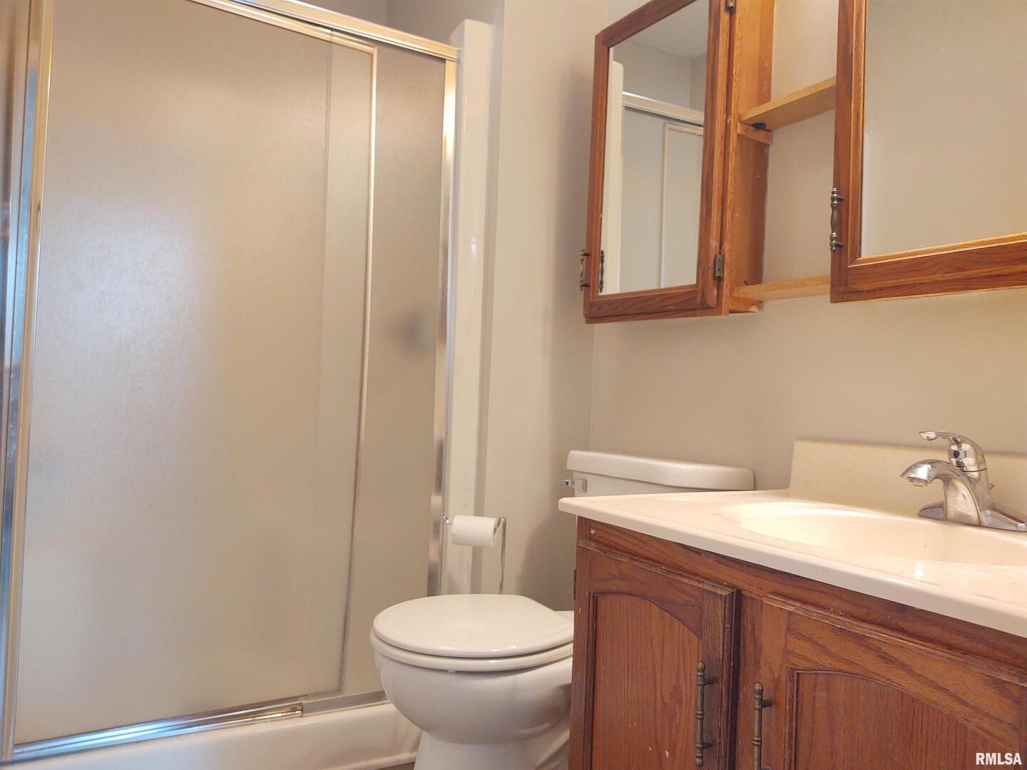 110 Stork Street Anna, IL 62906 - Photo 21 of 27 a bathroom with a sink a toilet and mirror
