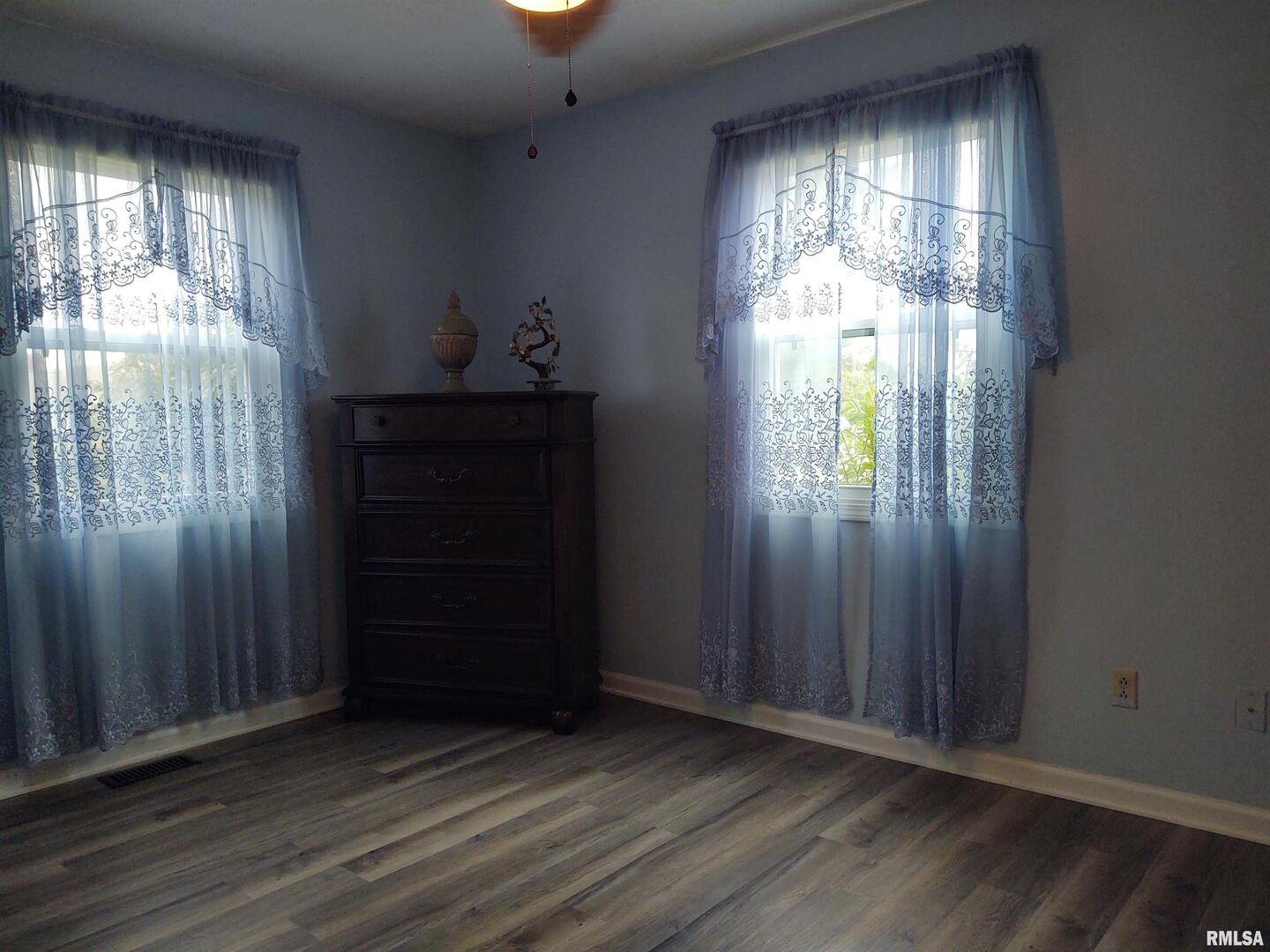 110 Stork Street Anna, IL 62906 - Photo 23 of 27 an empty room with wooden floor mirror and windows