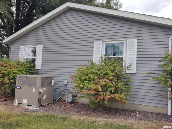 a view of a house with a yard and plants