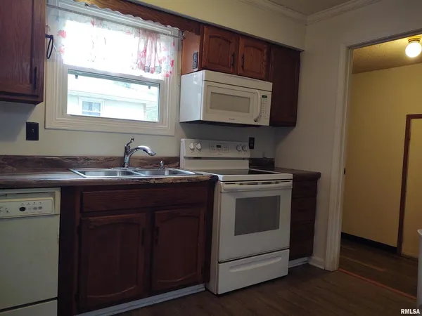 a kitchen with a sink stove and microwave
