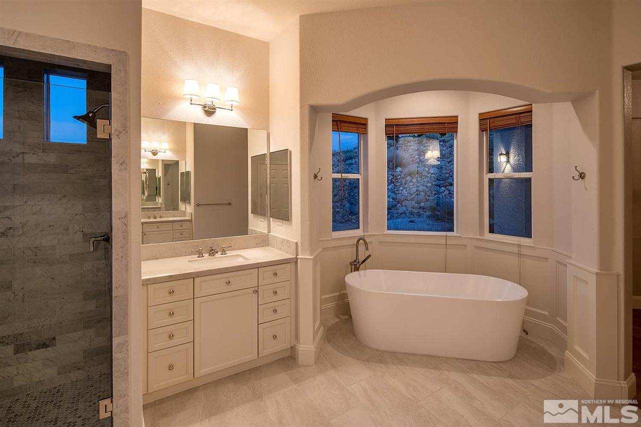 770 Sandoval Road Reno, NV 89511 - Photo 17 of 32 a bathroom with a tub a double vanity sink and mirror