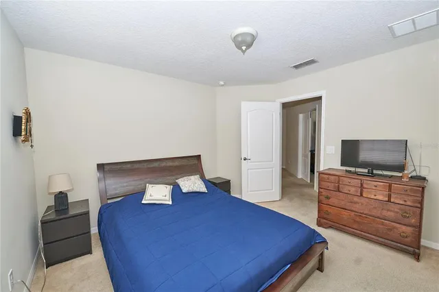 a view of a patio with table and chairs under an umbrella