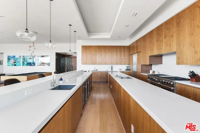 a kitchen with stainless steel appliances a sink stove and refrigerator