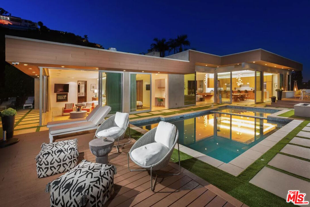 1429 Devlin Drive Los Angeles, CA 90069 - Photo 2 of 58 a view of a patio with couches table and chairs with wooden floor and fence