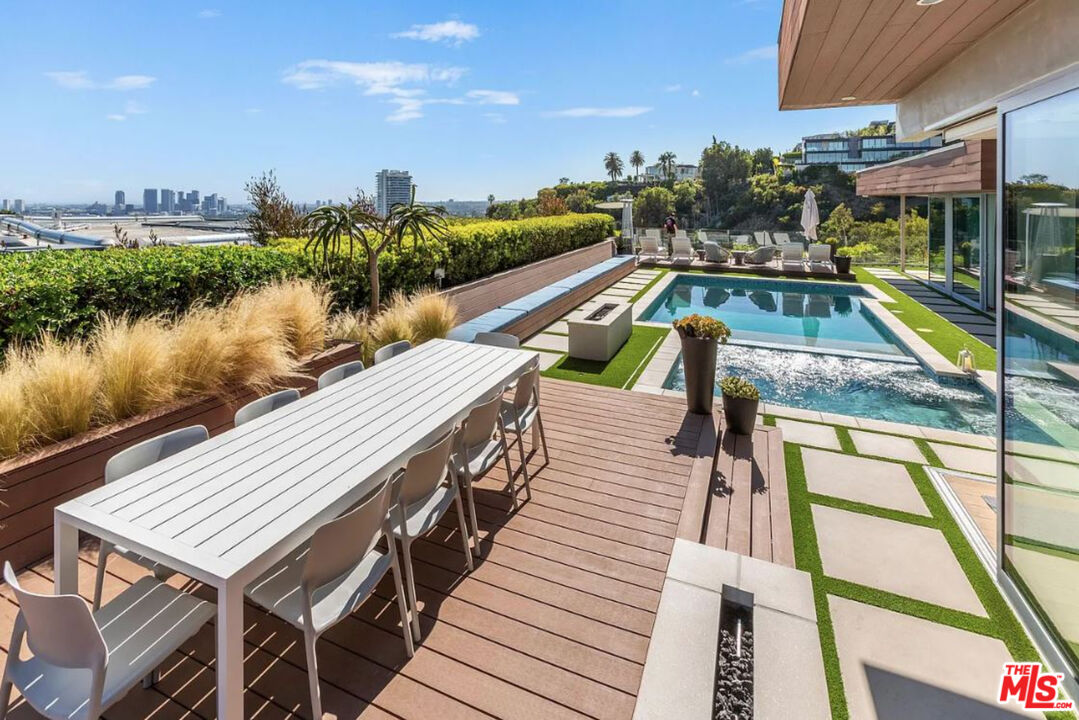 1429 Devlin Drive Los Angeles, CA 90069 - Photo 22 of 58 a view of a balcony with wooden floor and lake view