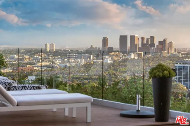 a view of a swimming pool with an outdoor seating and a garden