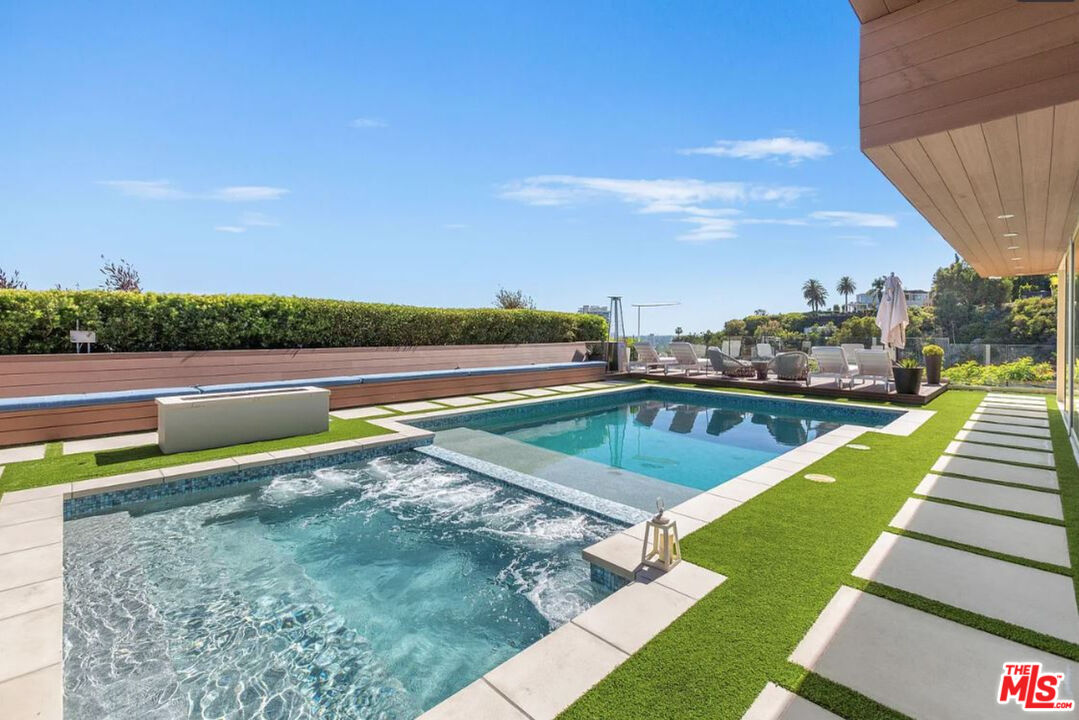 1429 Devlin Drive Los Angeles, CA 90069 - Photo 27 of 58 a view of a swimming pool with an outdoor seating and a garden