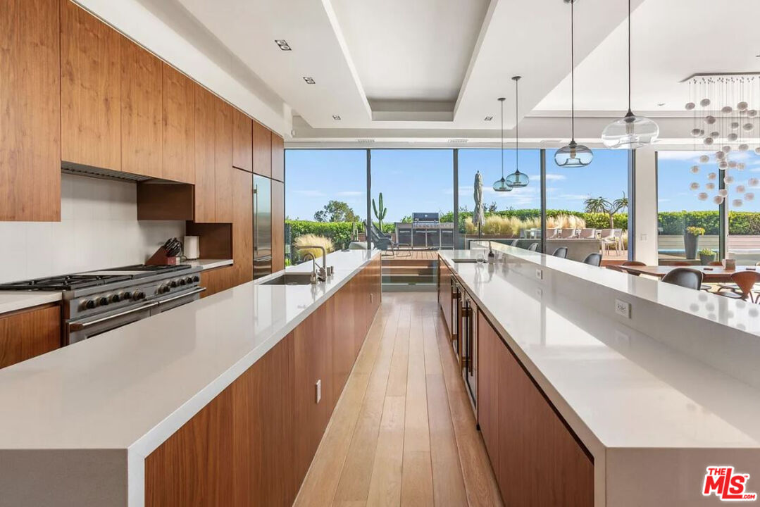 1429 Devlin Drive Los Angeles, CA 90069 - Photo 29 of 58 a kitchen with stainless steel appliances a sink a counter top space and a view of living room