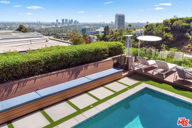 a view of a living room and kitchen space