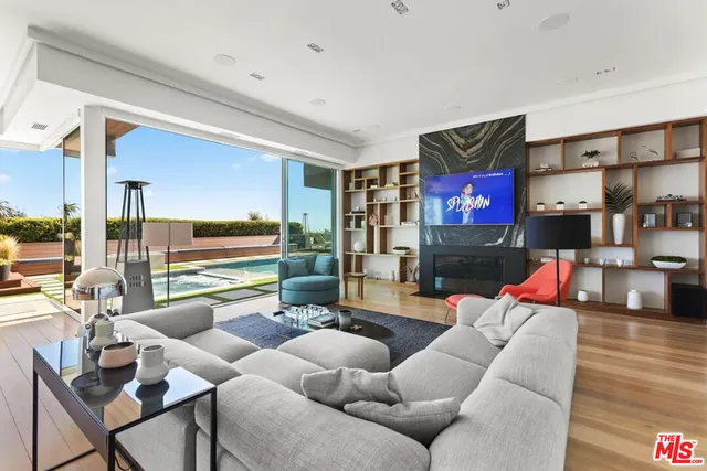 a living room with furniture and a floor to ceiling window