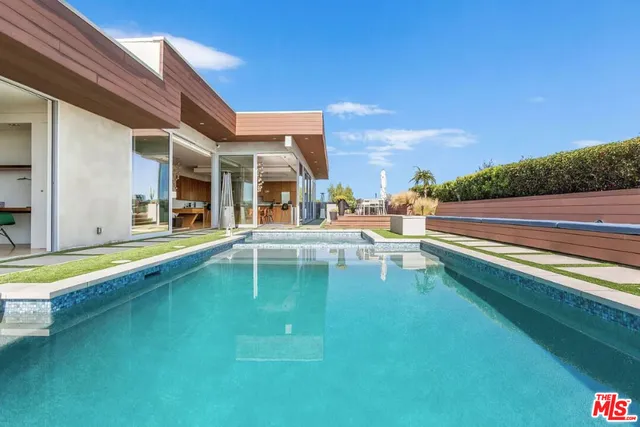 a view of a swimming pool with a lounge chairs