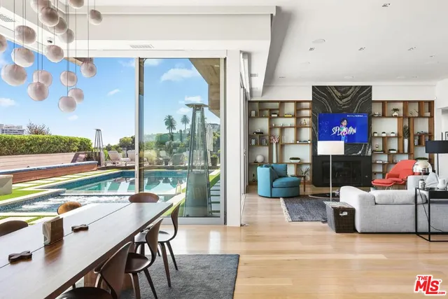 a view of a house with swimming pool and sitting area