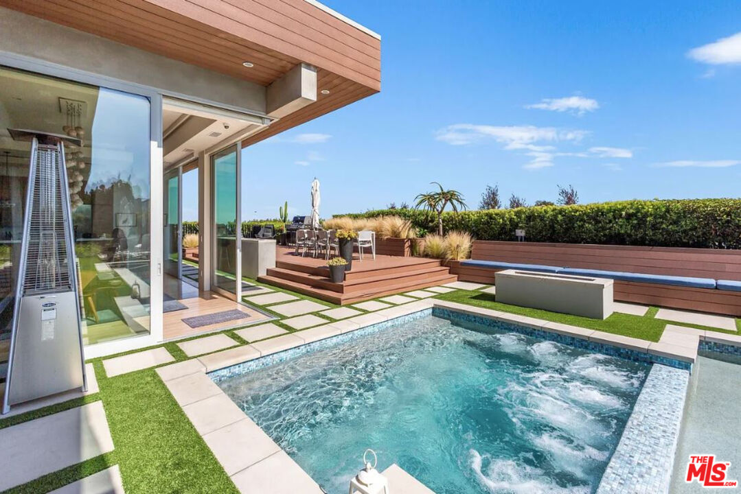 1429 Devlin Drive Los Angeles, CA 90069 - Photo 35 of 58 a view of a swimming pool with a lounge chairs