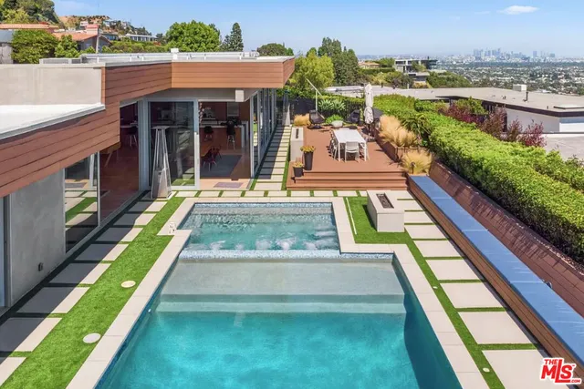 a view of house with swimming pool outdoor seating