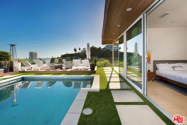 a kitchen with a stove a kitchen island a table and chairs in it