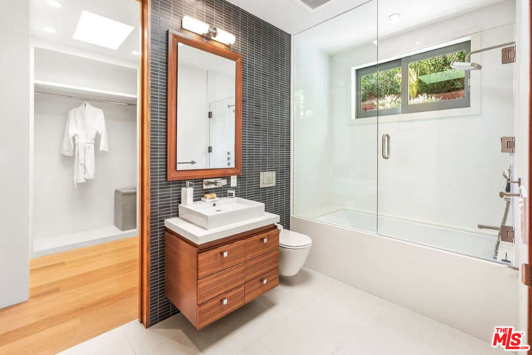 1429 Devlin Drive Los Angeles, CA 90069 - Photo 47 of 58 a bathroom with a tub sink toilet and mirror