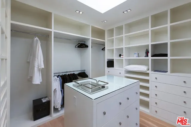 a bedroom with a bed and large window