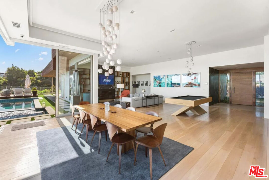 1429 Devlin Drive Los Angeles, CA 90069 - Photo 49 of 58 a dining hall with stainless steel appliances kitchen island granite countertop a table chairs and a view of living room