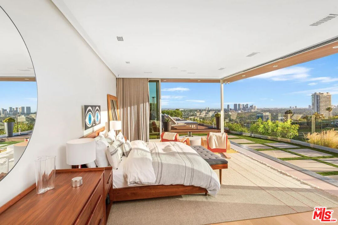 1429 Devlin Drive Los Angeles, CA 90069 - Photo 50 of 58 a room with a bed and large windows