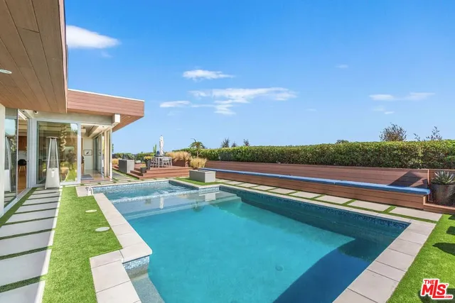 a view of swimming pool with lounge chair
