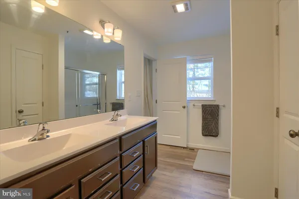 a bathroom with a sink a light fixture and a mirror
