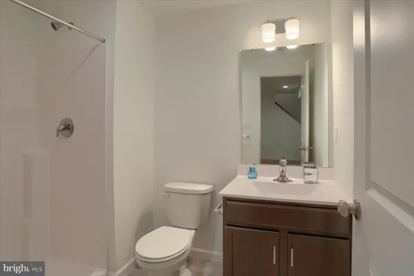 a bathroom with a sink vanity and toilet