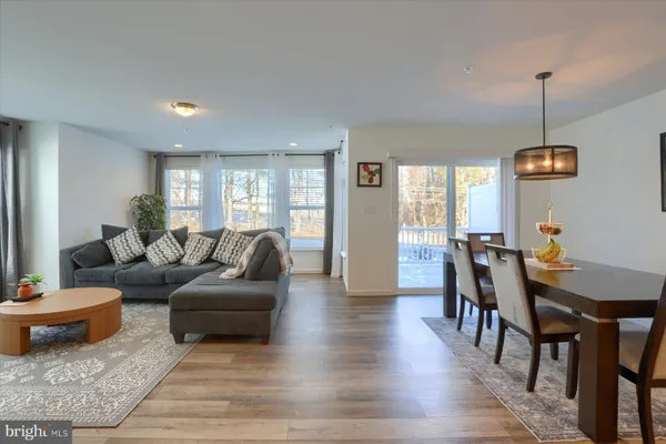 a living room with furniture a wooden floor and a window
