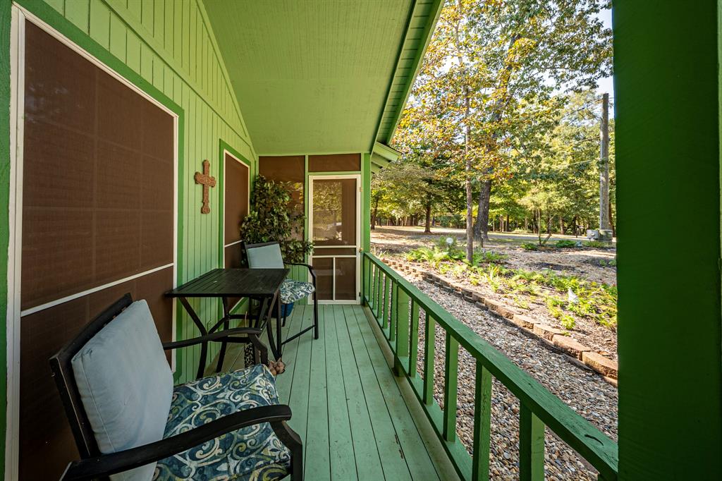 746 Wildwood Trail Holly Lake Ranch, TX 75765 - Photo 23 of 27 a view of balcony with furniture and garden