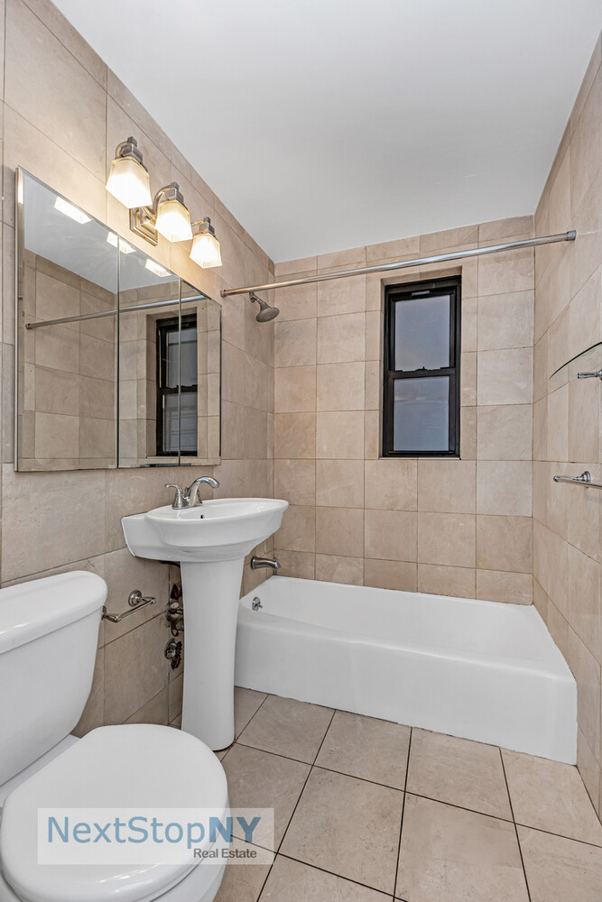241 East 76th Street, Unit 4I Manhattan, NY 10021 - Photo 5 of 11 a bathroom with a sink toilet and shower