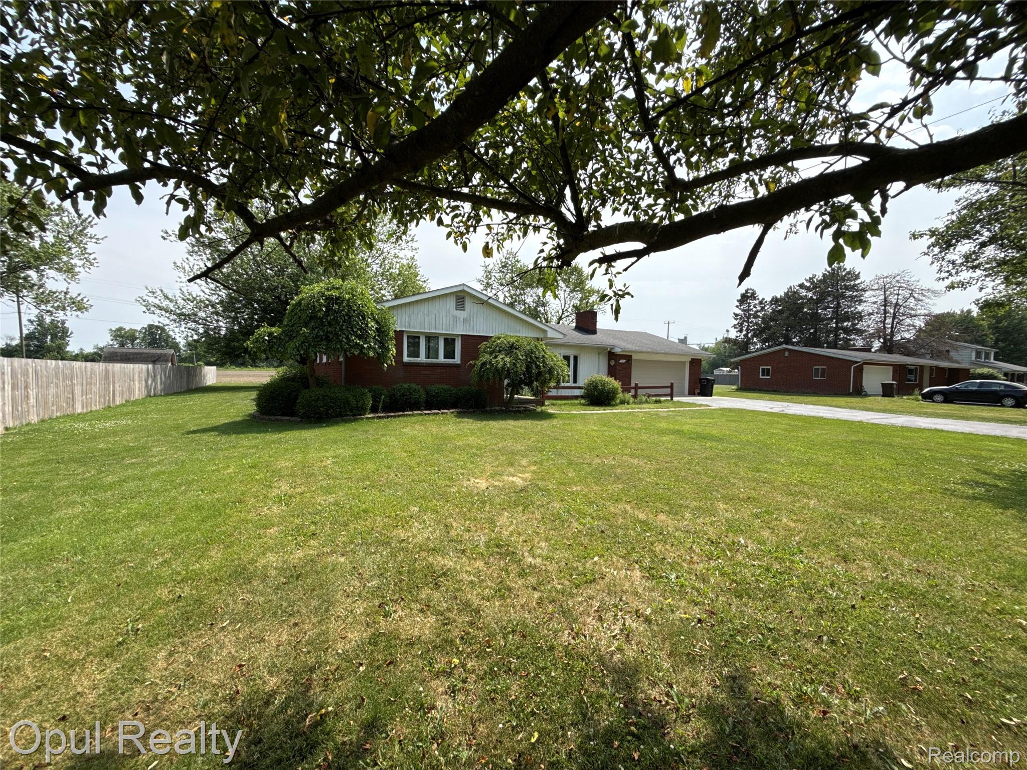 7899 Ida East Road Ida, MI 48140 - Photo 8 of 48 Ranch-style residence featuring a brick facade, white siding, and a gabled roofline