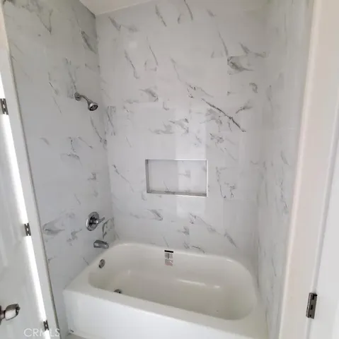 a white bath tub sitting in a bathroom