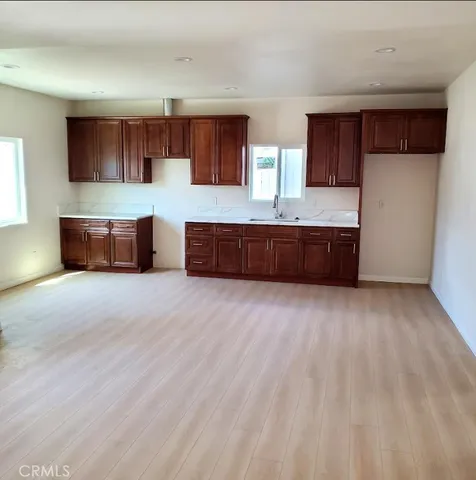 a large kitchen with stainless steel appliances granite countertop a large counter top and a stove