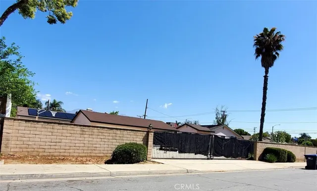 a view of a street with potted plants